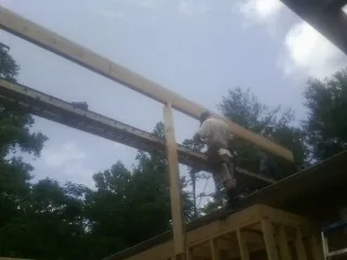 Carpenter setting a ridge beam over a new addition frame — Ice Dam Removal by Roofing Brothers in South Tamworth