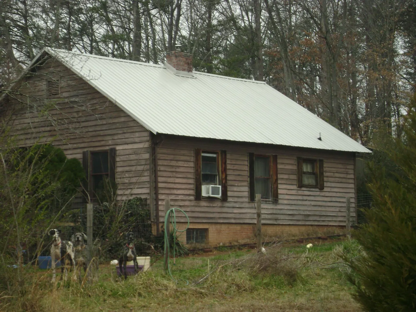 White metal roof on an old wood sided farmhouse, from a Metal Roof Installation job in South Tamworth